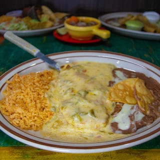 Hamburger Steak Topped with Chile con Queso, Served with Refried Beans and Spanish Rice. Choice of Corn or Flour Tortillas