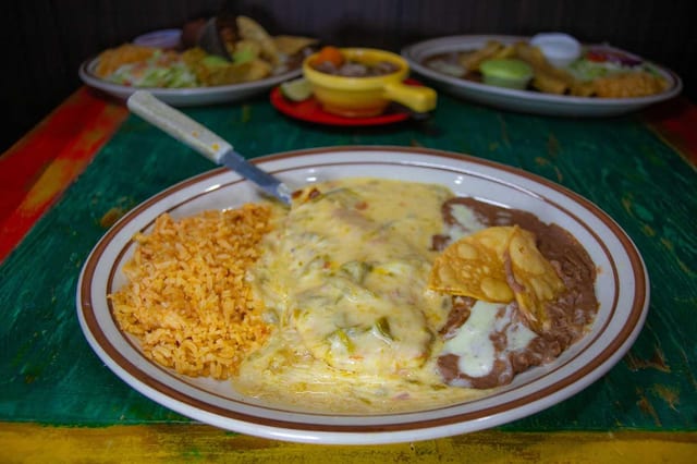 Hamburger Steak Topped with Chile Con Queso, Served with Refried Beans and Spanish Rice. Choice of Corn or Flour Tortillas